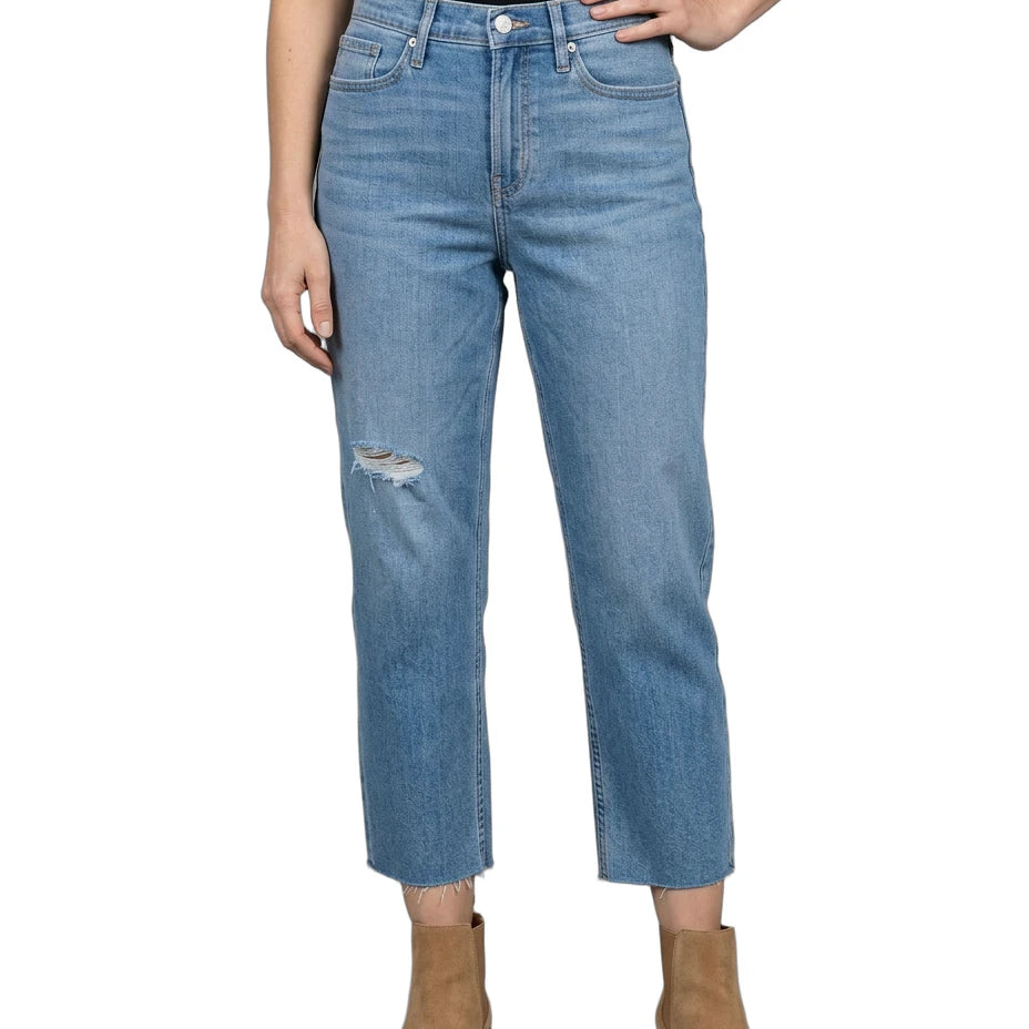 Person wearing light blue jeans with a white background