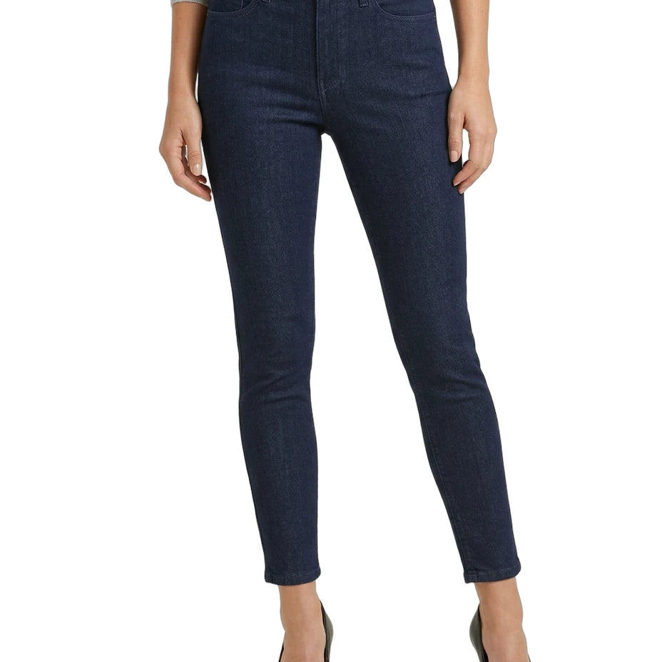 Dark blue jeans worn by a person on a white background
