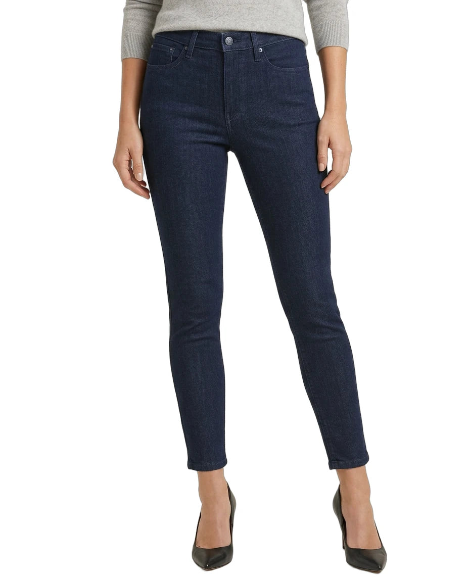 Dark blue jeans worn by a person on a white background