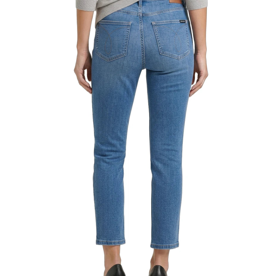 Blue jeans worn by a person on a white background
