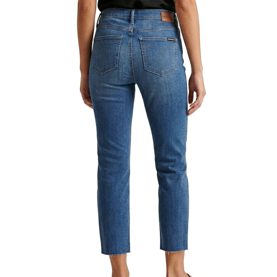 Person wearing blue jeans on a white background