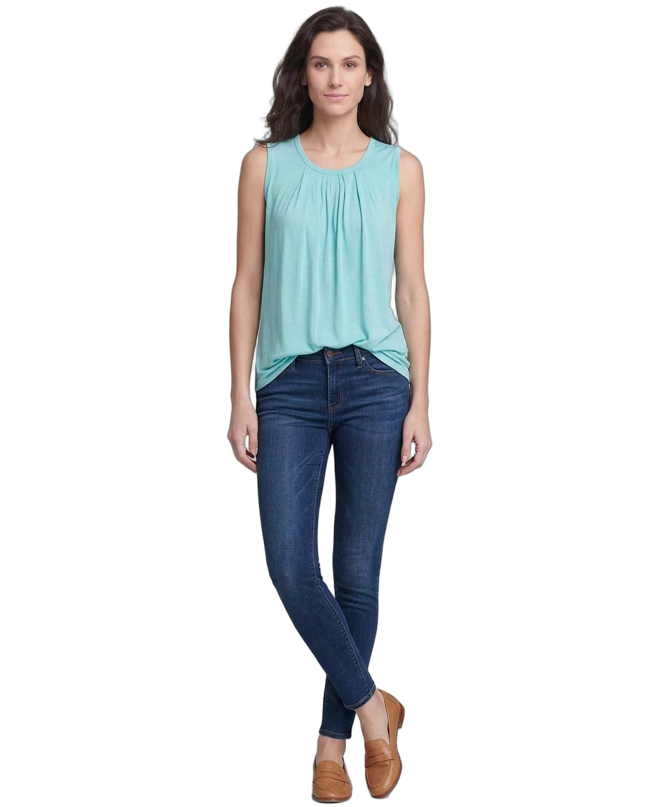 Woman wearing a light blue sleeveless top and dark blue jeans on a white background