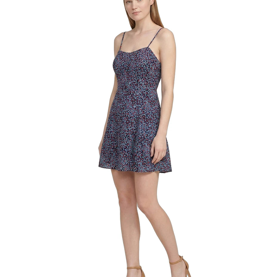 Woman wearing a floral Calvin Klein dress on a white background