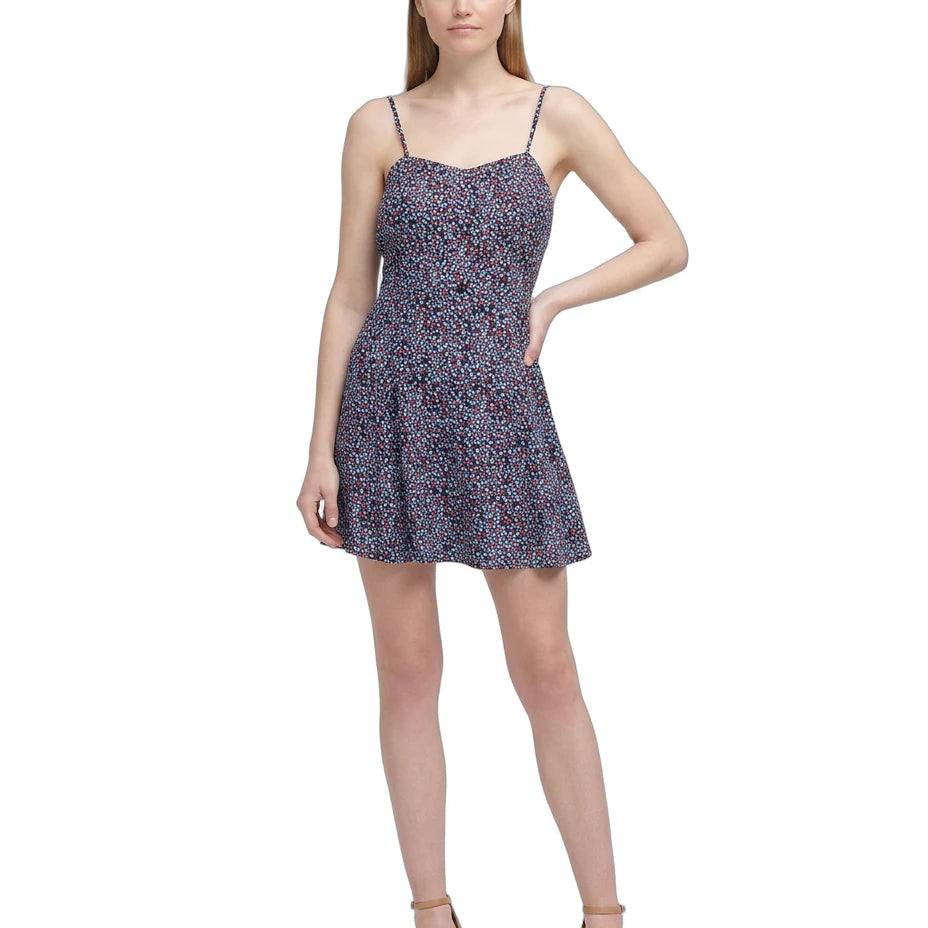 Woman wearing a floral Calvin Klein dress on a white background