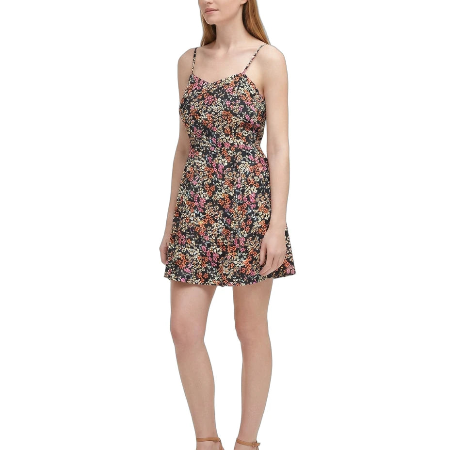 Woman wearing a floral Calvin Klein dress on a white background