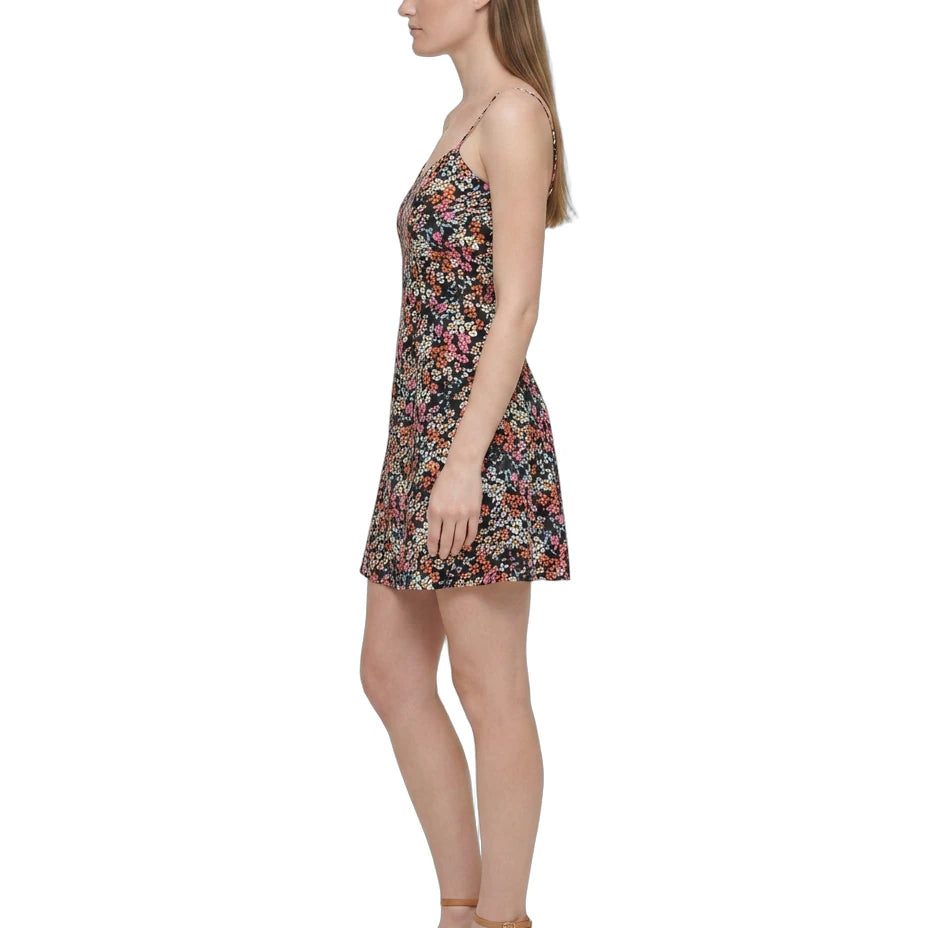 Woman wearing a floral Calvin Klein dress on a white background
