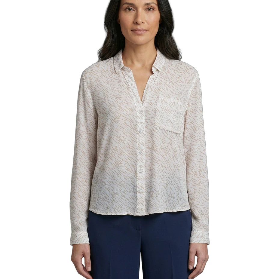 Woman wearing a light patterned Calvin Klein shirt and dark pants on a white background