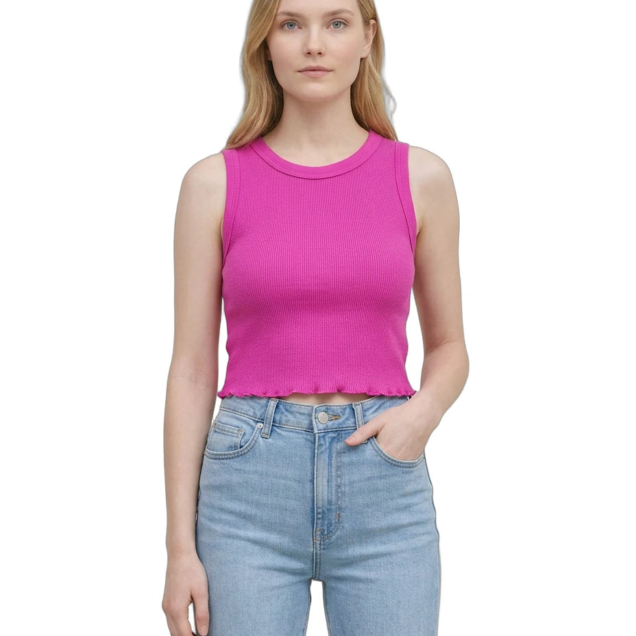 Woman wearing a bright pink sleeveless top and light blue jeans on a white background