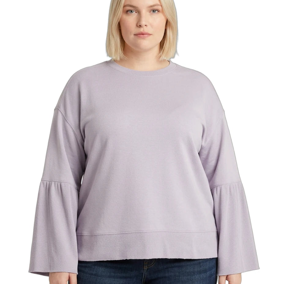 Woman wearing a light purple Calvin Klein sweater with ruffled sleeves on a white background