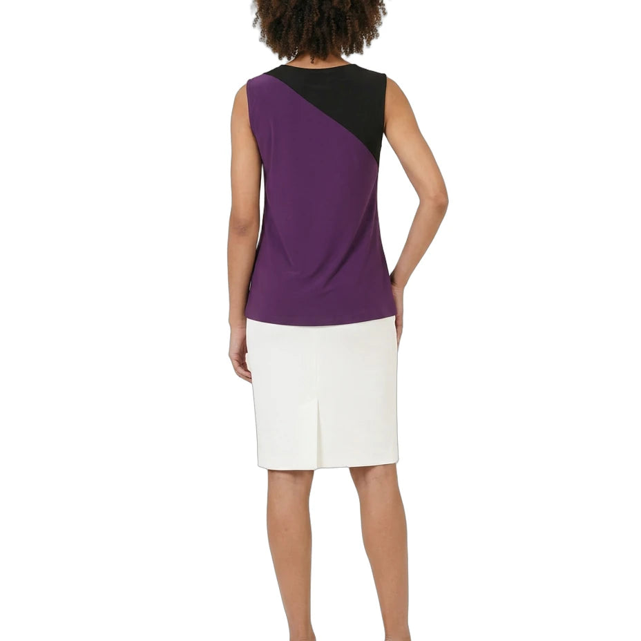 Woman wearing a two-tone dress with purple and black top and white skirt on a white background
