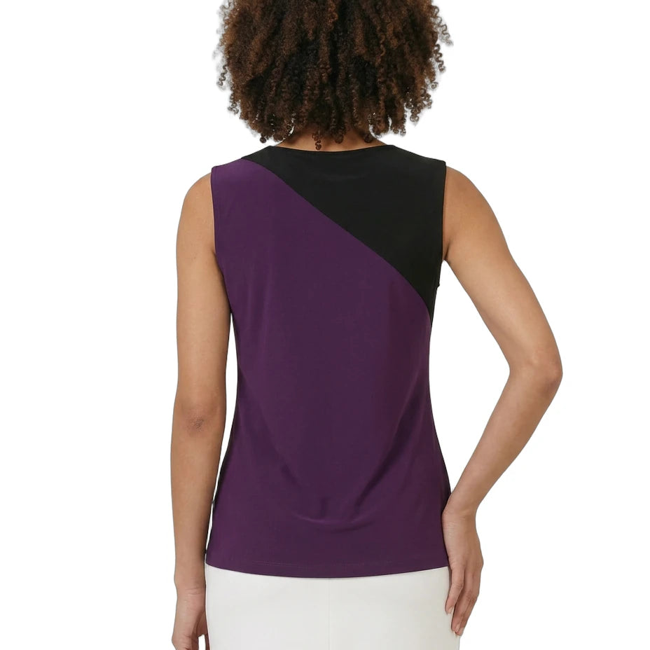 Woman wearing a sleeveless top with purple and black color block design on a white background