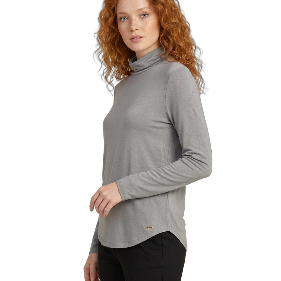 Woman wearing a gray turtleneck sweater on a white background