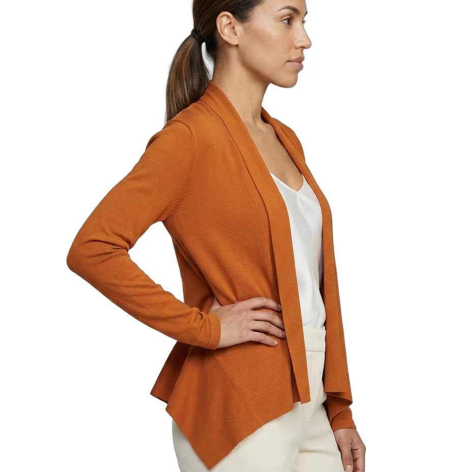 Woman wearing an orange Calvin Klein cardigan over a white top on a white background
