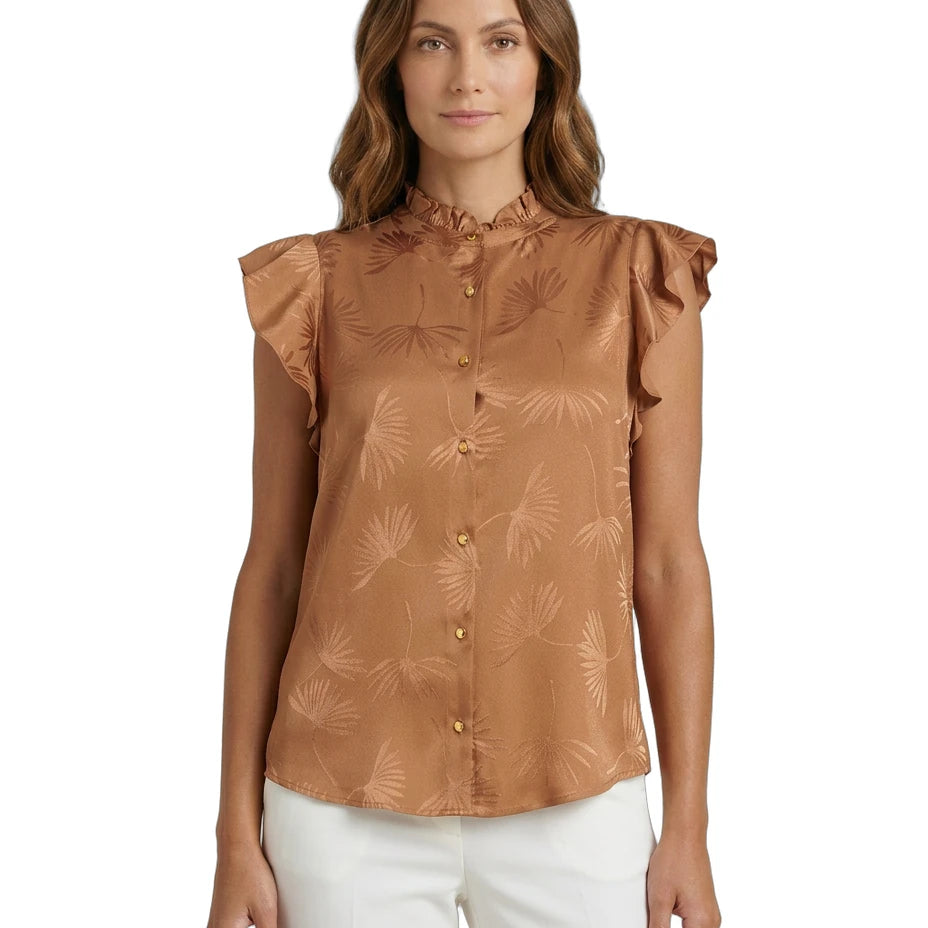 Woman wearing a brown Calvin Klein blouse with floral pattern on a white background