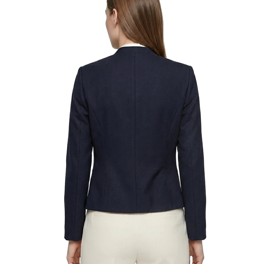 Navy Calvin Klein blazer worn by a person on a white background