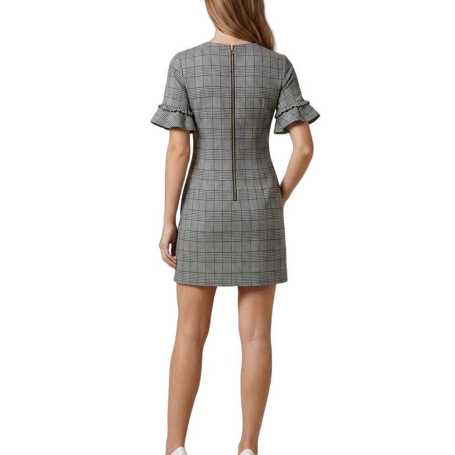 Woman wearing a Calvin Klein gray checkered dress with ruffled sleeves on a white background