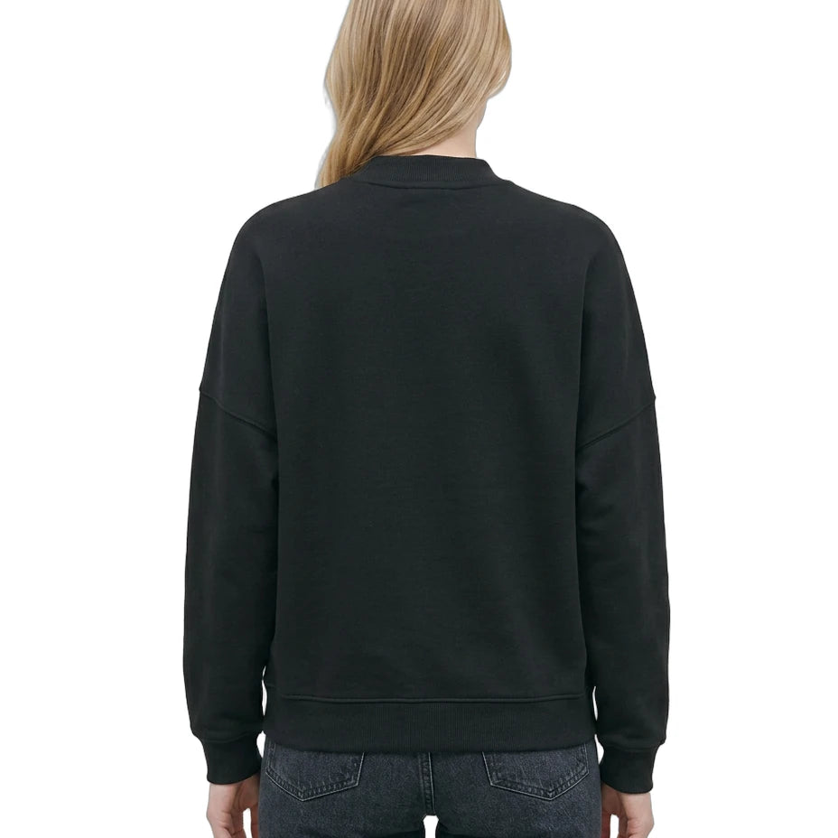 Woman wearing a Calvin Klein black sweatshirt with a brand logo on a white background