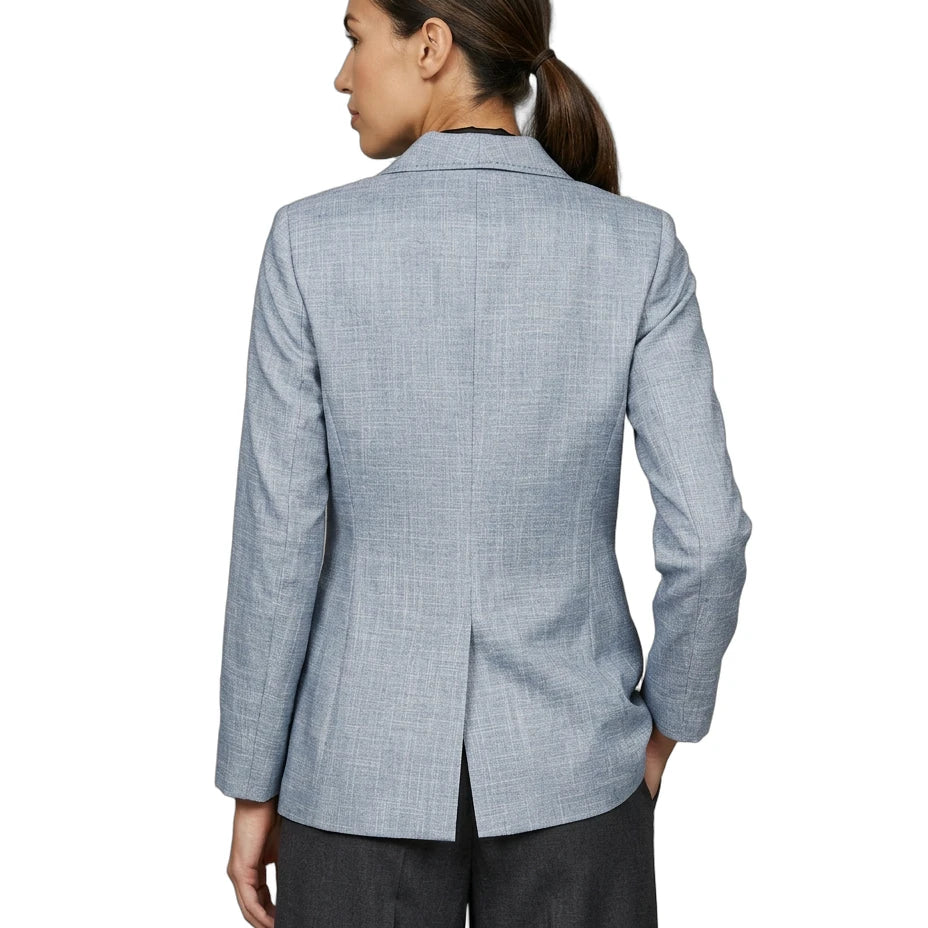 Person wearing a light blue Calvin Klein checkered blazer on a white background