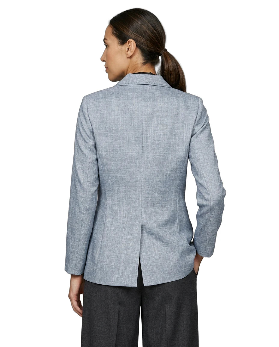 Person wearing a light blue Calvin Klein checkered blazer on a white background