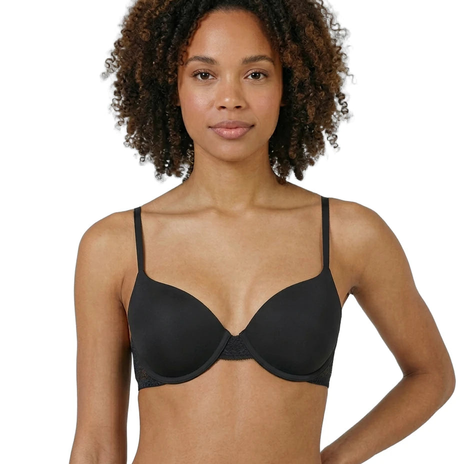 Woman wearing a black Calvin Klein bra on a white background