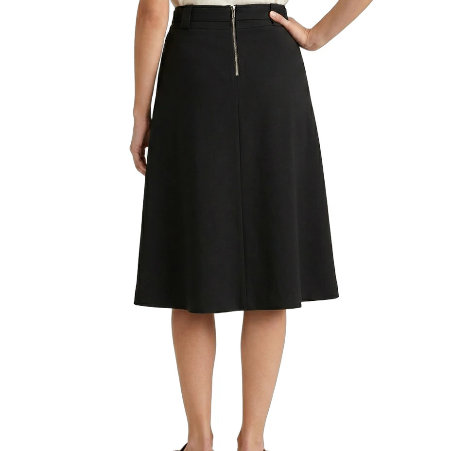 Person wearing a black Calvin Klein skirt on a white background