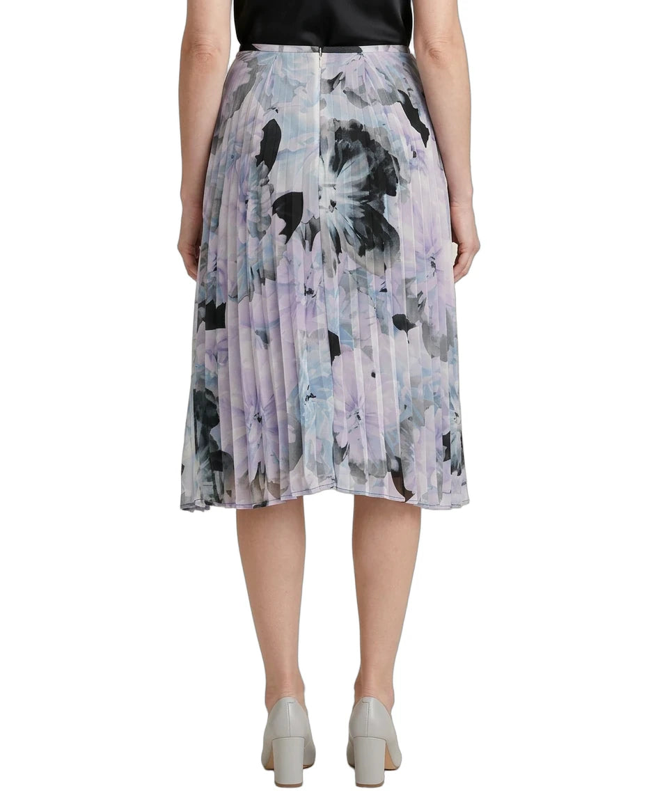 Person wearing a Calvin Klien pleated skirt with abstract floral pattern on a white background