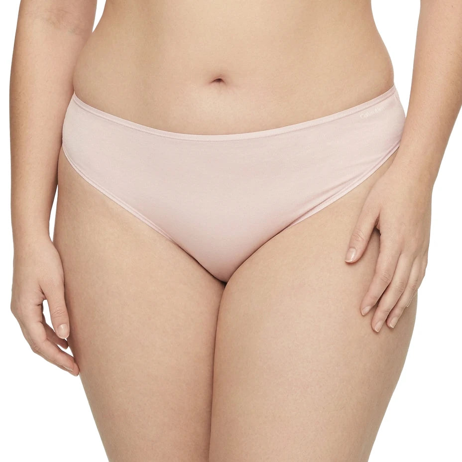 Light pink bikini bottom worn by a person on a white background