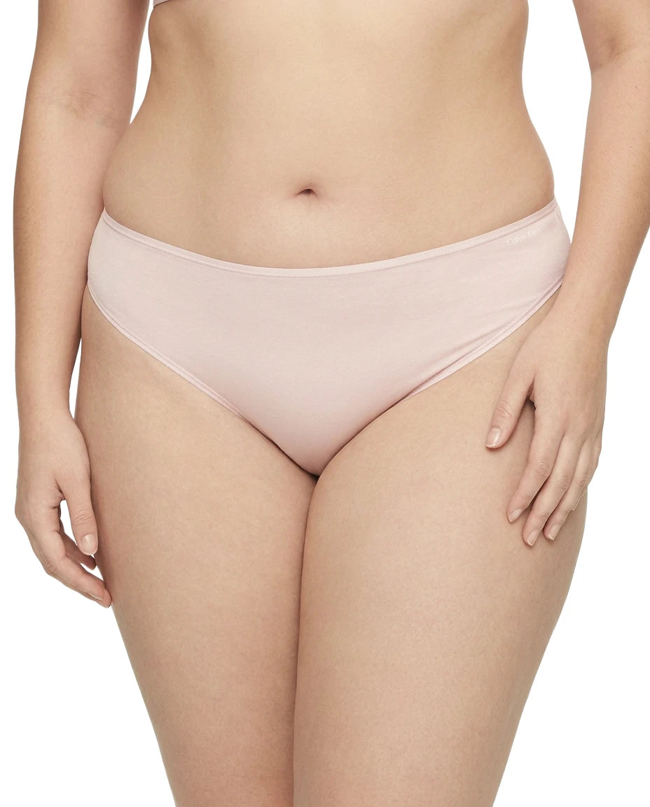 Light pink bikini bottom worn by a person on a white background