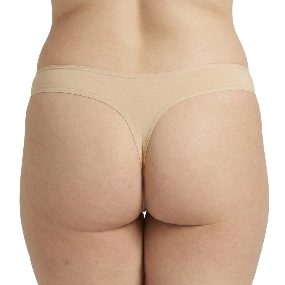 Beige underwear worn by a person on a white background