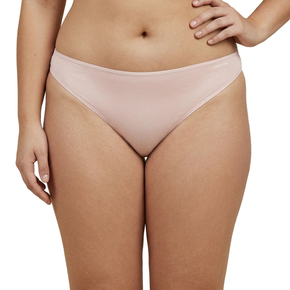 Light pink bikini bottom worn by a person on a white background