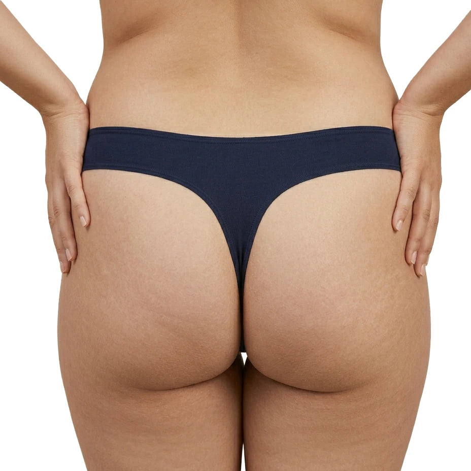 Person wearing a dark blue thong on a white background