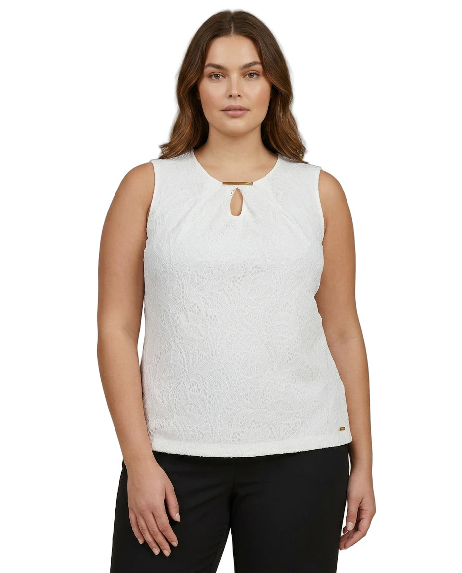 Woman wearing a white sleeveless Calvin Klein top with a cut-out design on a white background