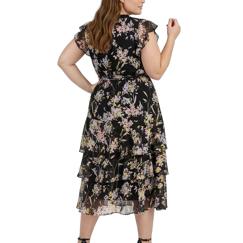 Woman wearing a black Calvin Klein floral dress on a white background