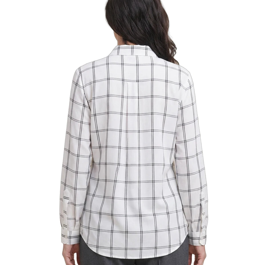 Person wearing a white and black checkered Calvin Klein shirt on a white background