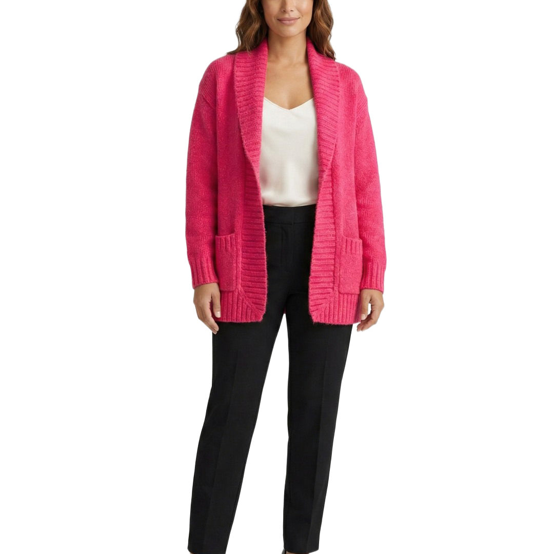 Woman wearing a bright pink cardigan over a white top and black pants on a white background