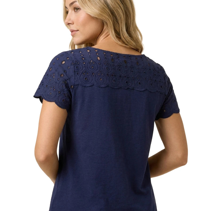Back view of a blonde woman wearing the Charter Club petite navy blue cotton top showing the embroidered eyelet upper back and scalloped edges.
