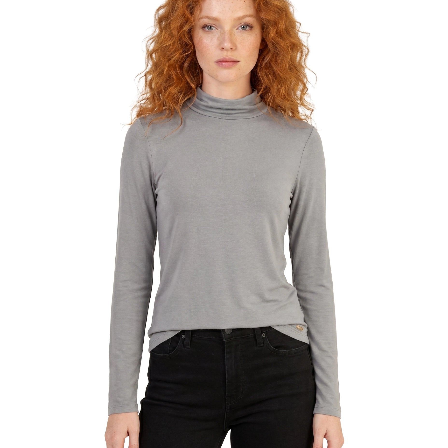 Woman wearing a gray turtleneck sweater and black pants on a white background