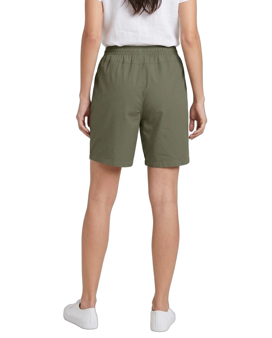 Person wearing green shorts on a white background
