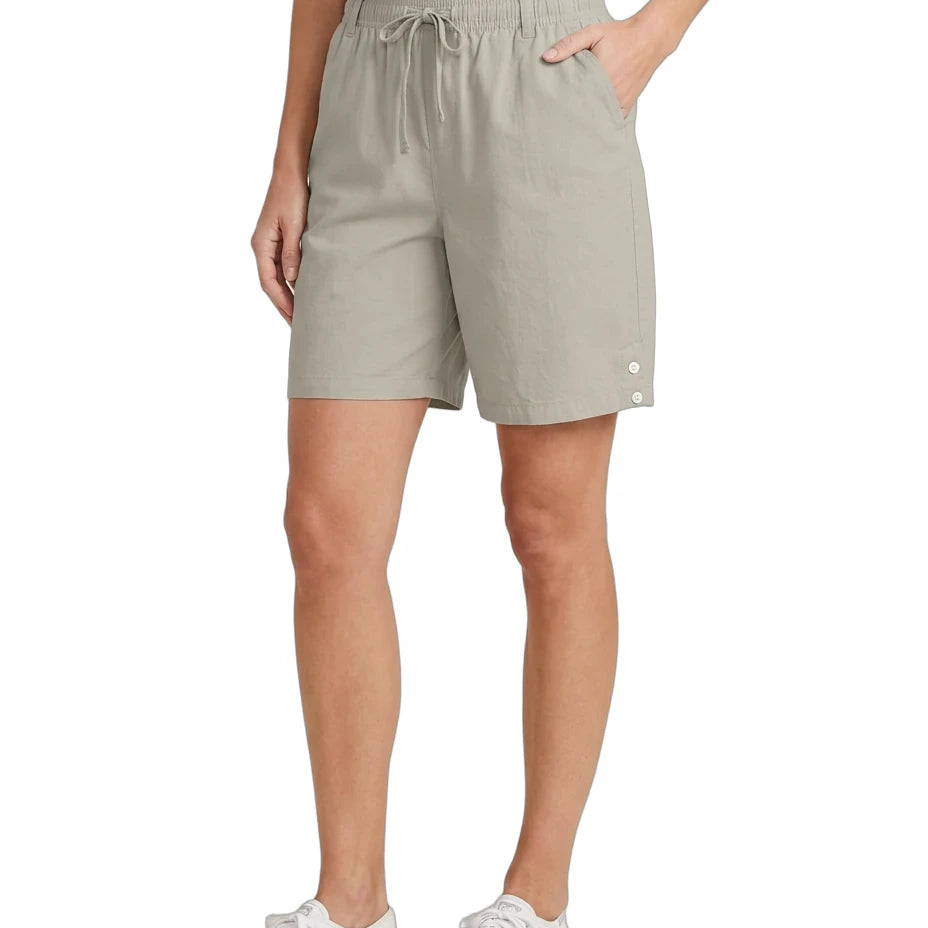 Person wearing beige shorts on a white background