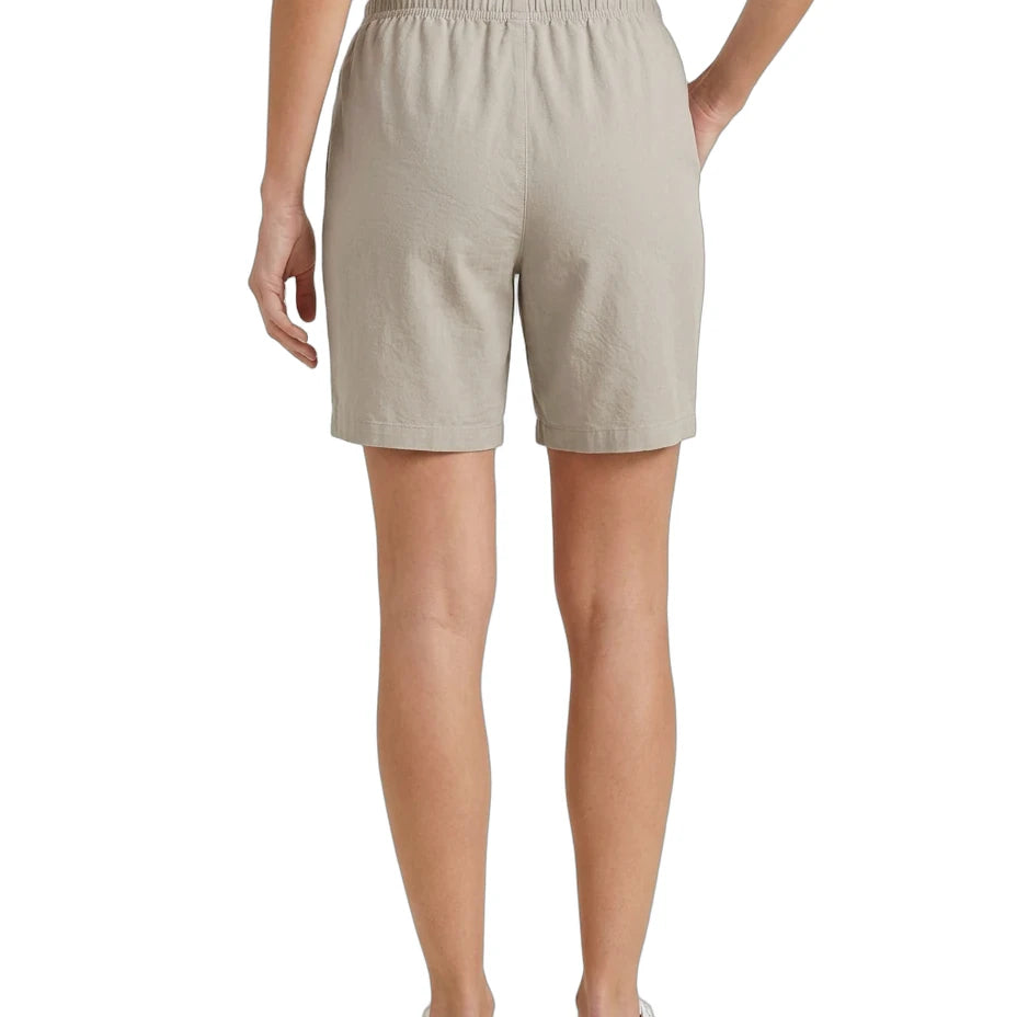 Beige shorts worn by a person on a white background
