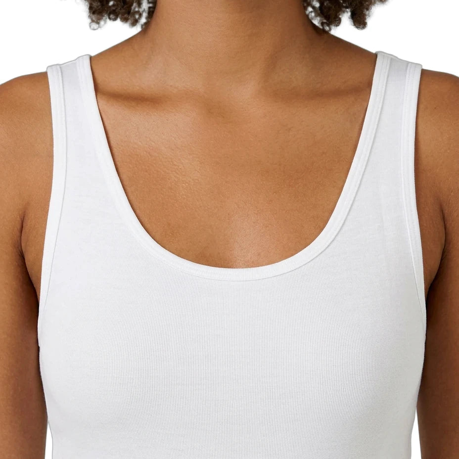 White tank top worn by a person on a white background