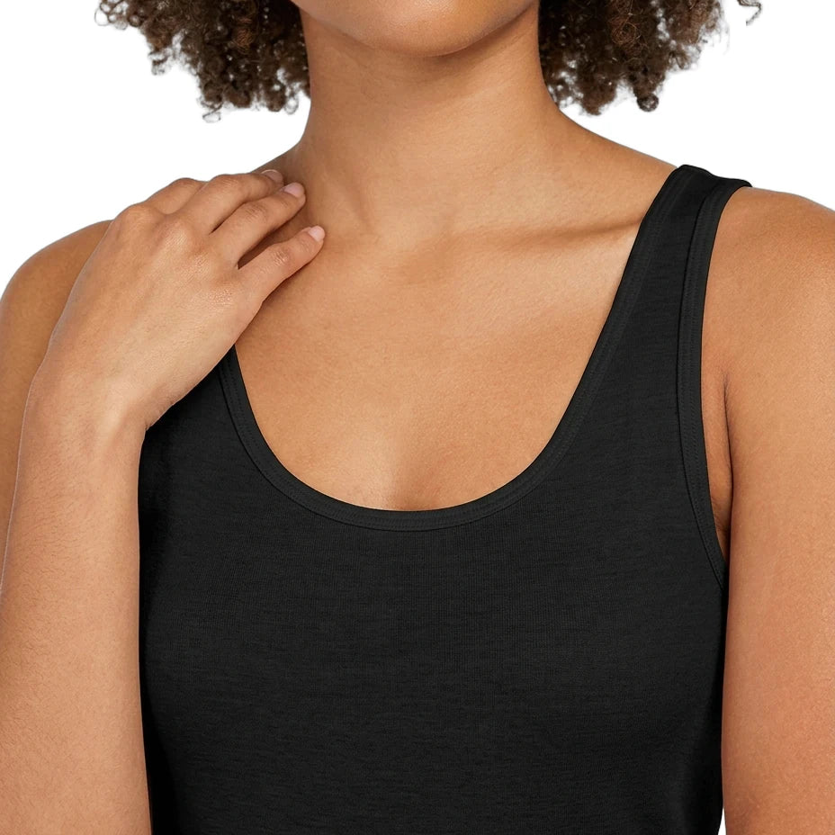 Woman wearing a black tank top against a white background
