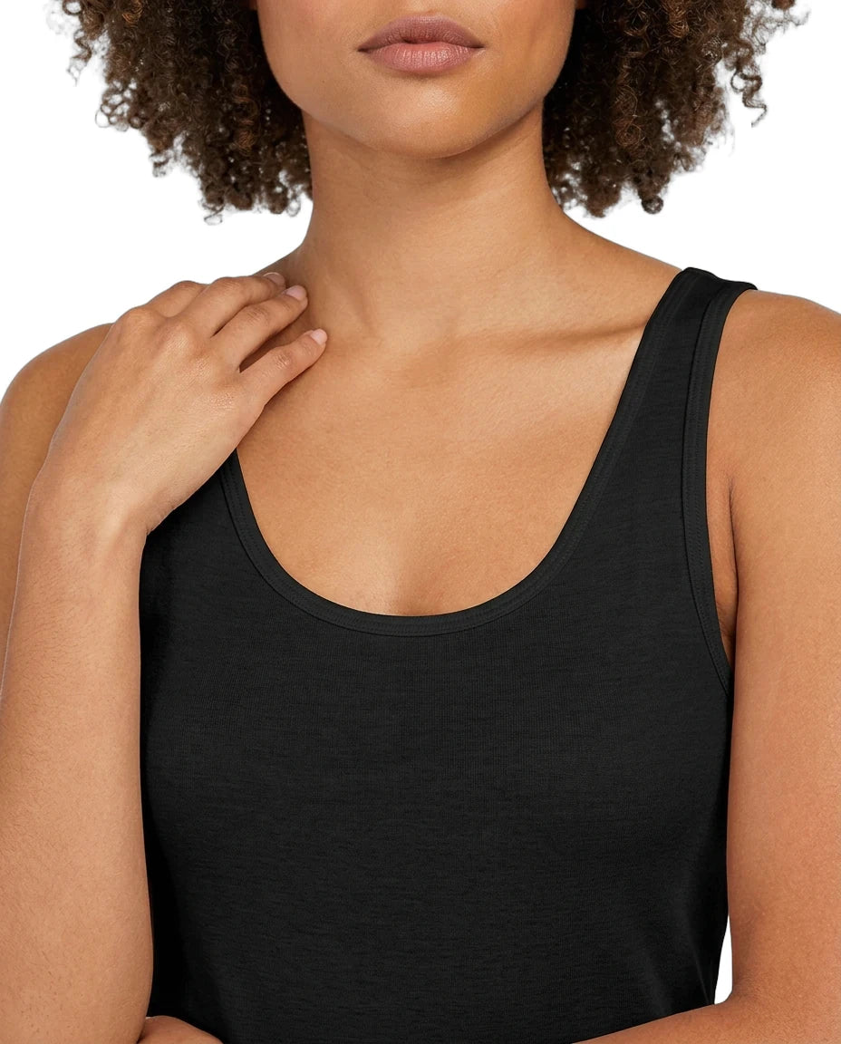Woman wearing a black tank top against a white background