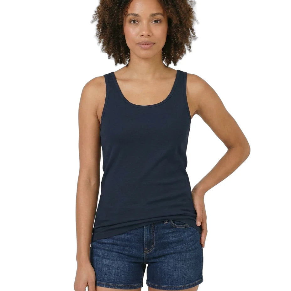 Woman wearing a navy tank top and denim shorts on a white background