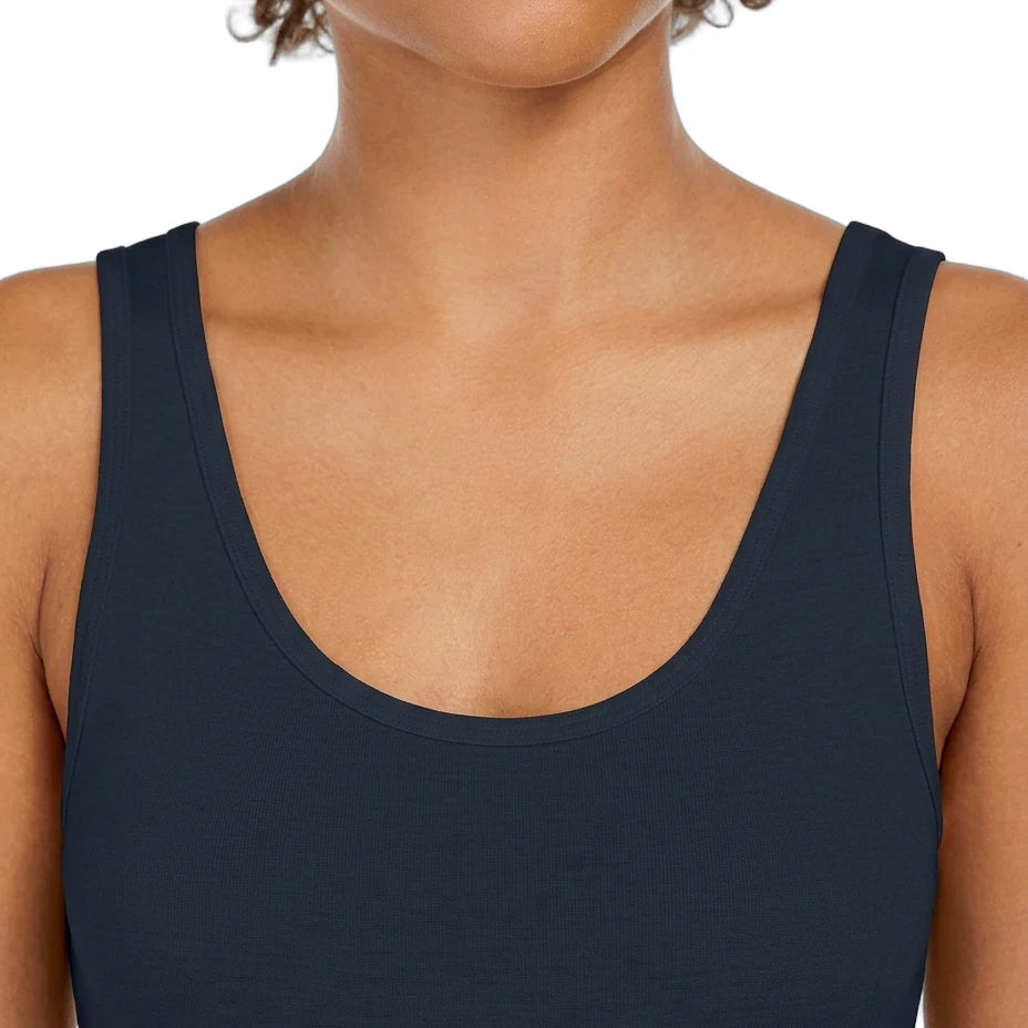 Person wearing a black tank top on a white background