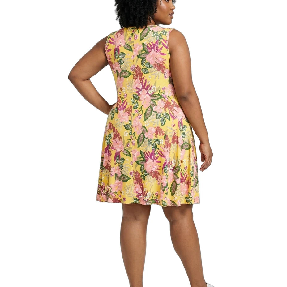 Woman wearing a yellow floral dress on a white background
