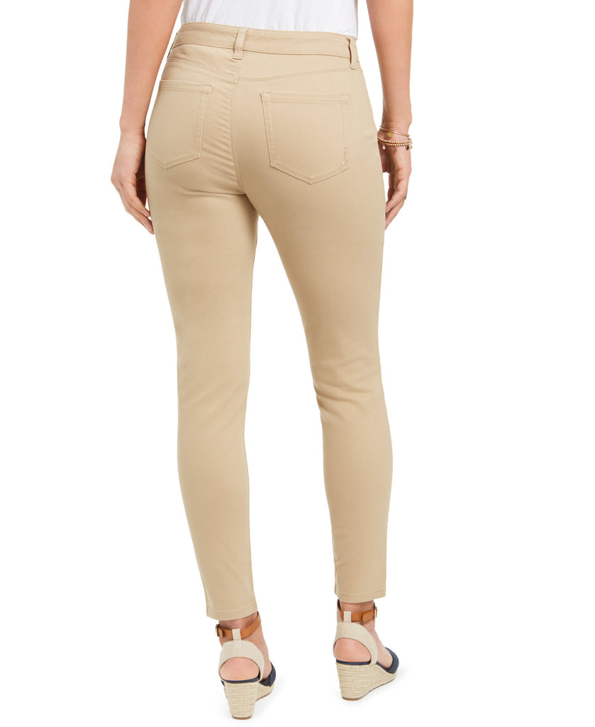 Beige pants worn by a person on a white background