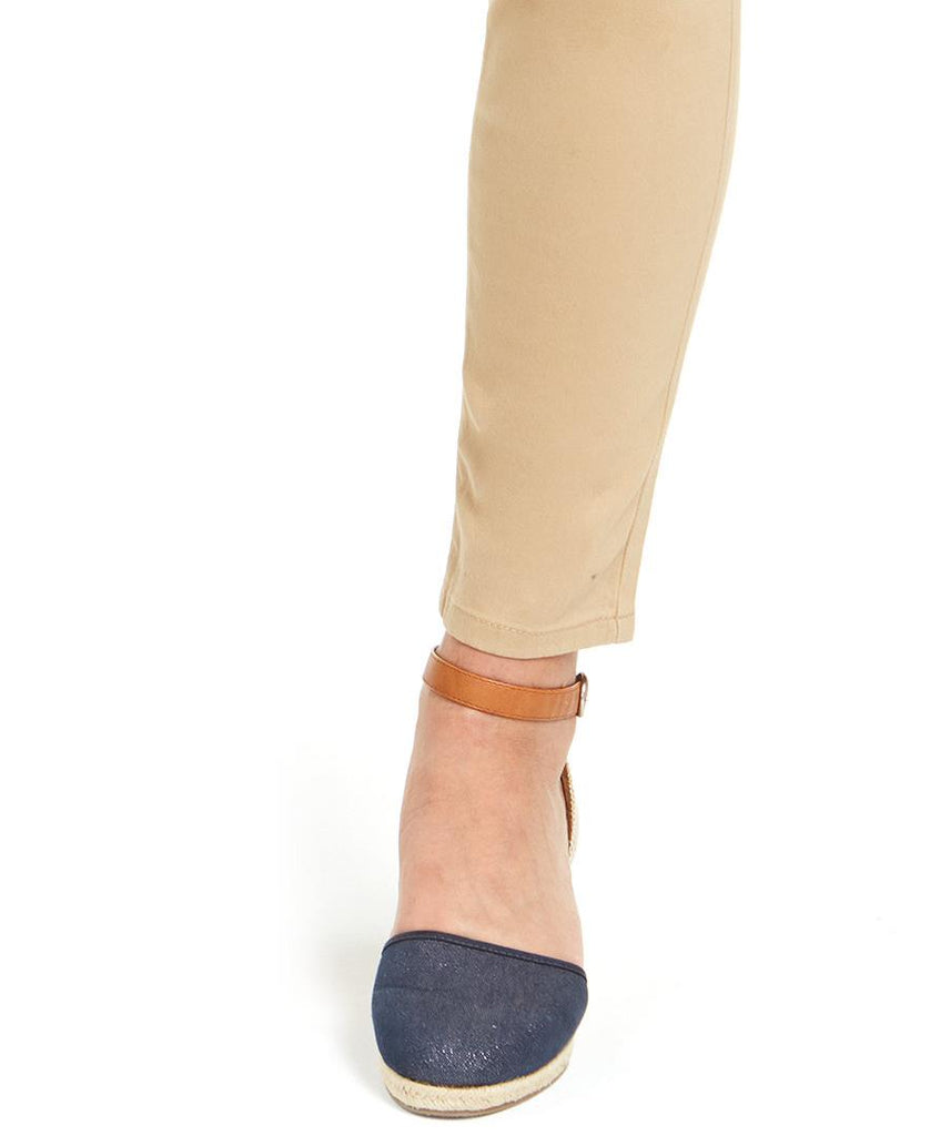 Denim wedge sandal worn with beige pants on a white background