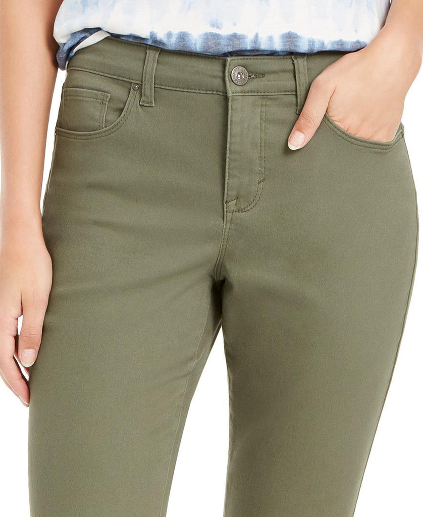 Olive green pants worn by a person on a white background