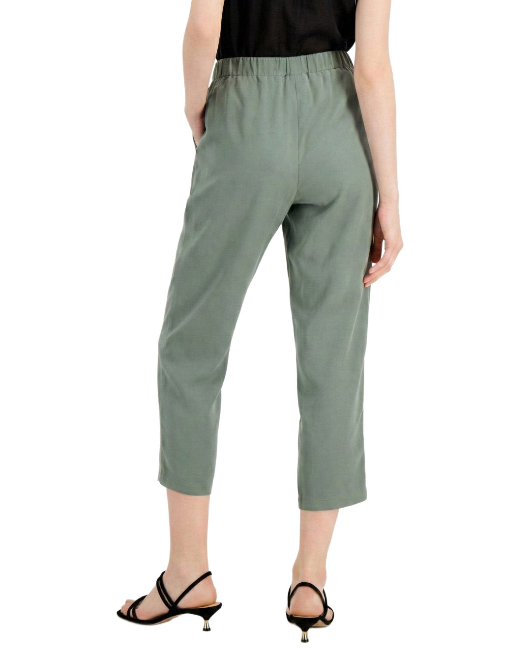 Person wearing green pants on a white background